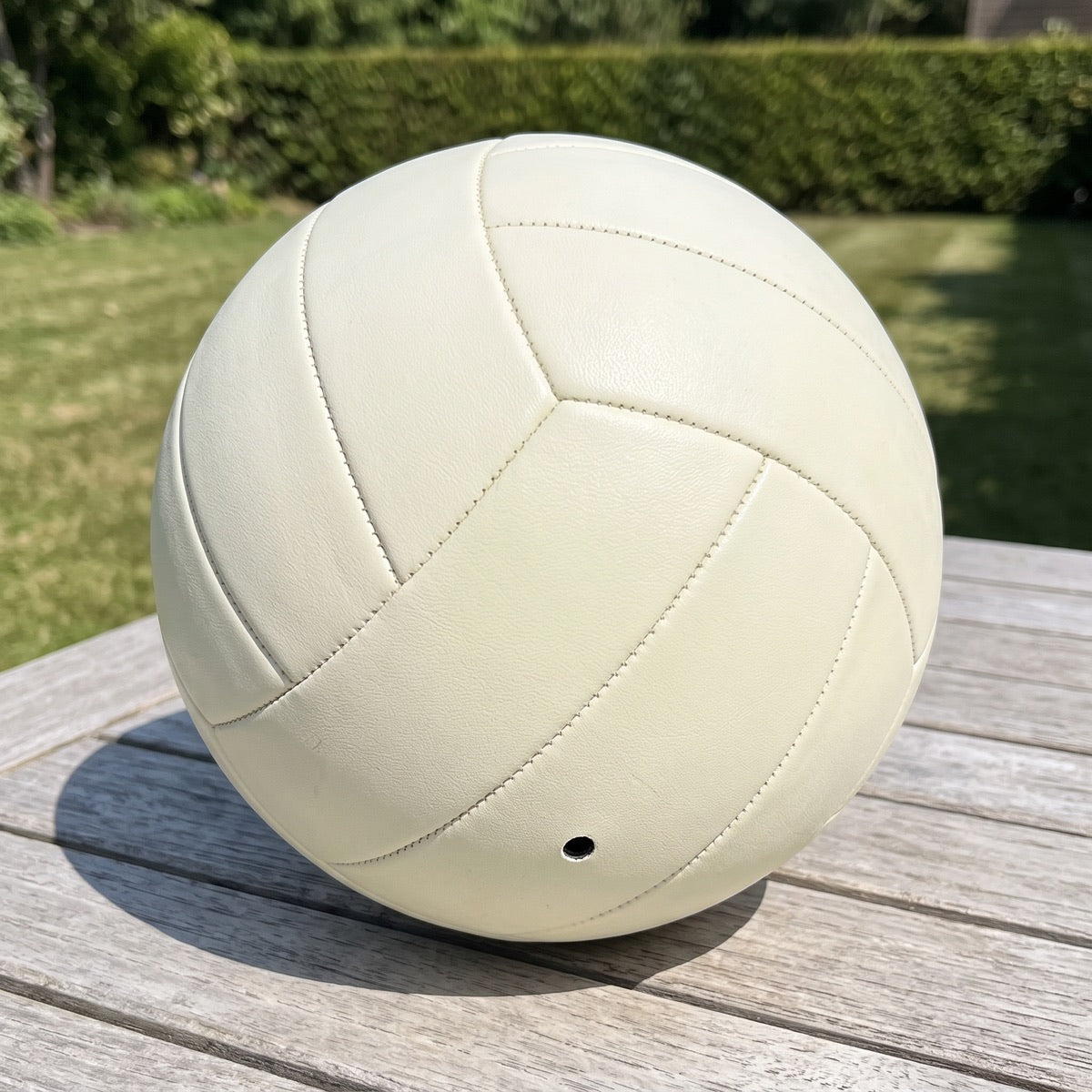 Leuchtvolley bei Tag auf einem Gartentisch und im Dunkeln leuchtend